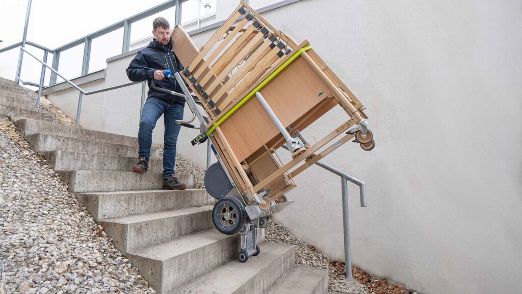 LiftKar HD Pro UNI carrying a hospital bed up outdoor stairs