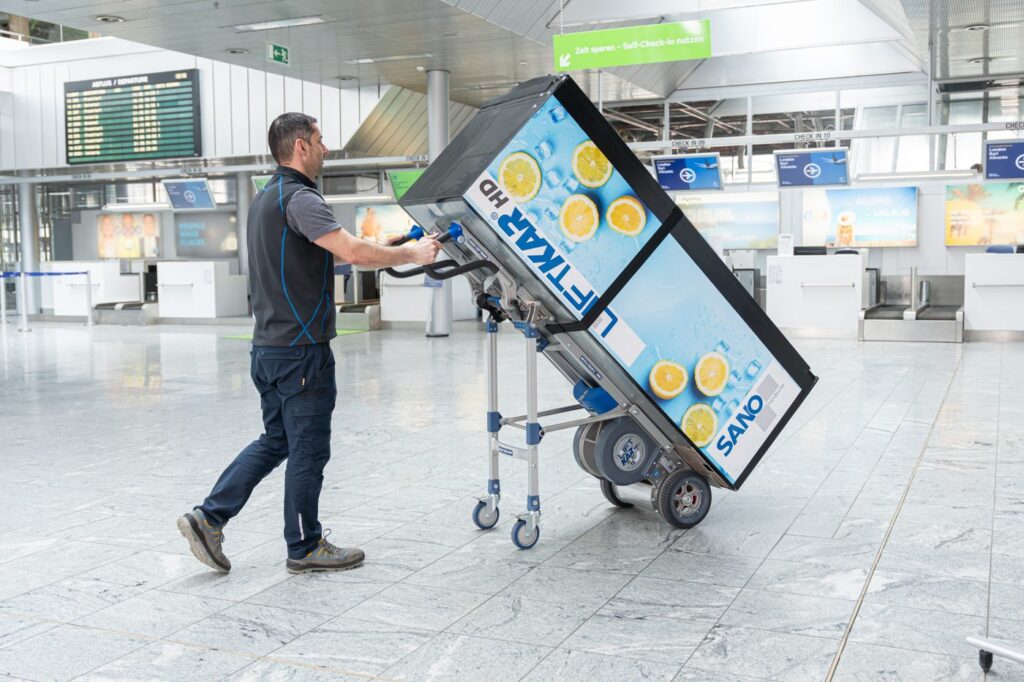 LiftKar HD Pro moving a beverage vending machine through an airport