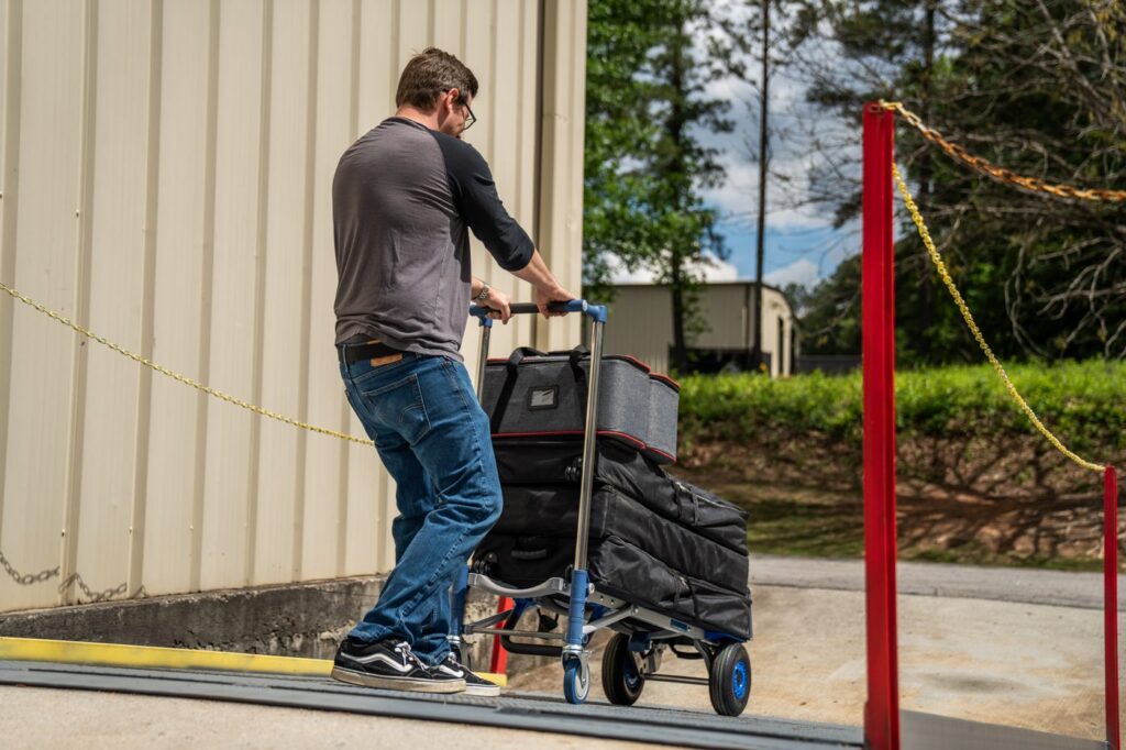 TwinKar HD rolling a load of gear cases past a velvet rope
